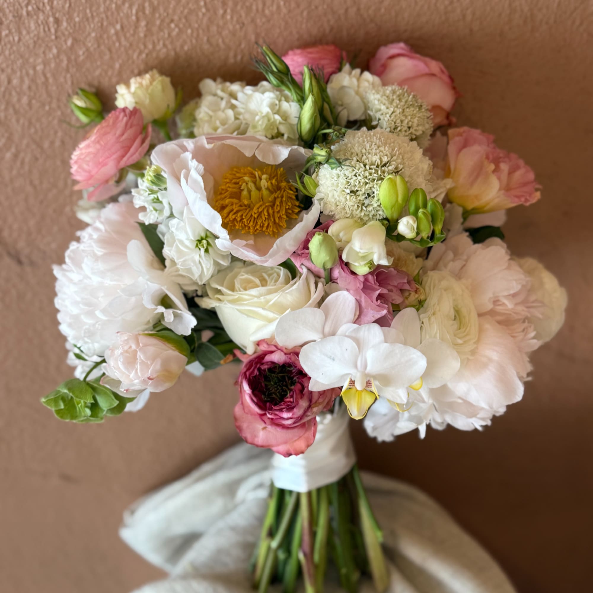 Pink and white mixed bouquet with roses and orchids