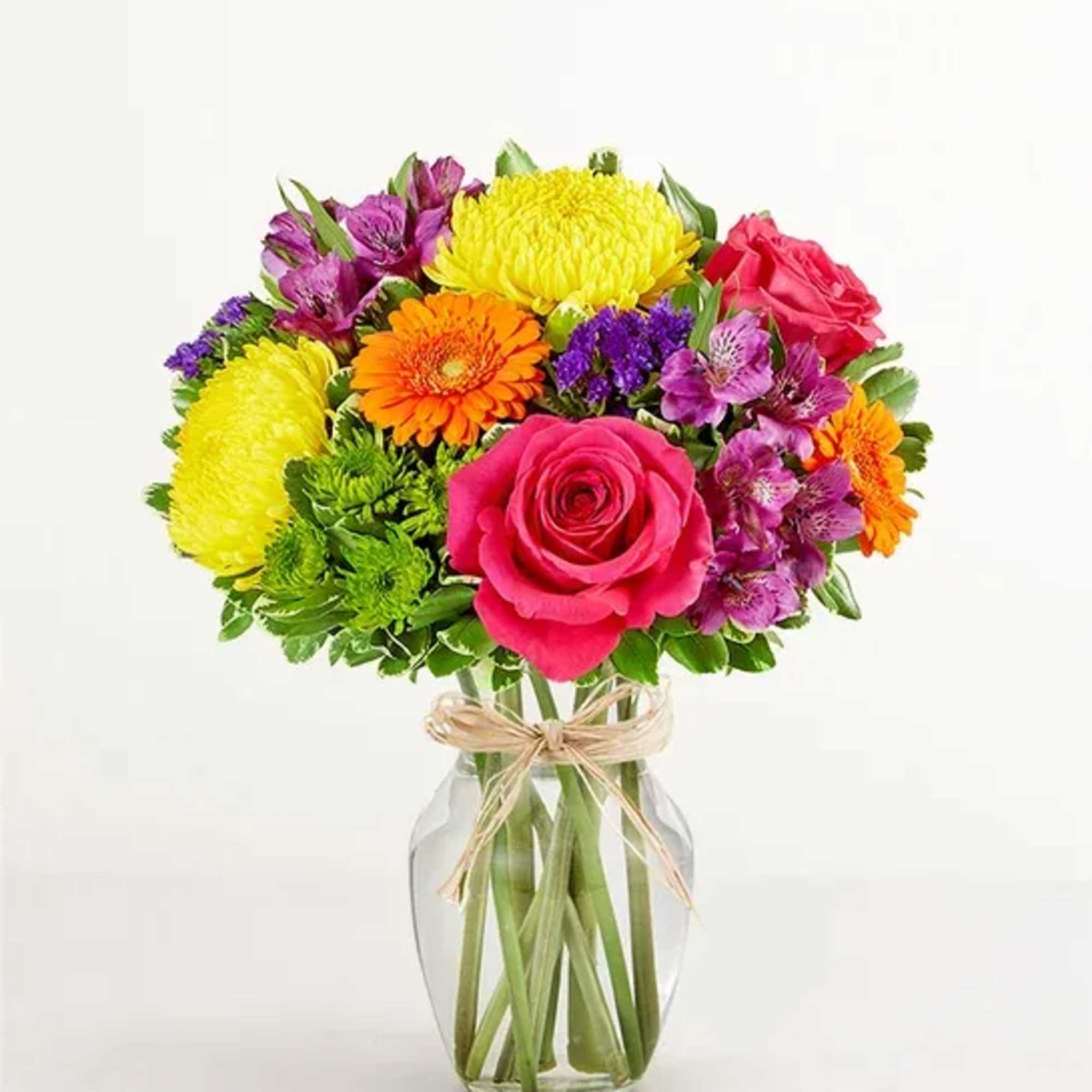 Colorful bouquet of roses, chrysanthemums, and alstroemeria in a glass vase