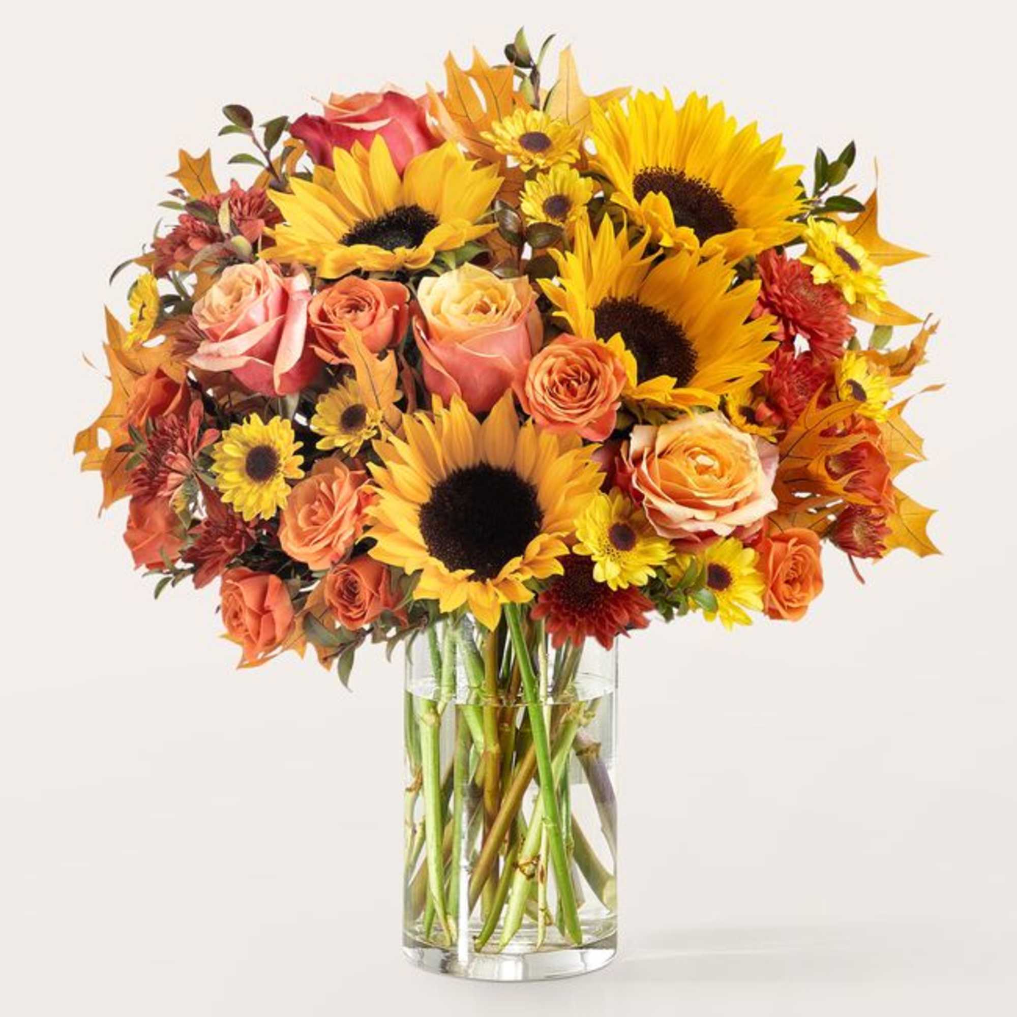 Bouquet of sunflowers and roses in a clear glass vase