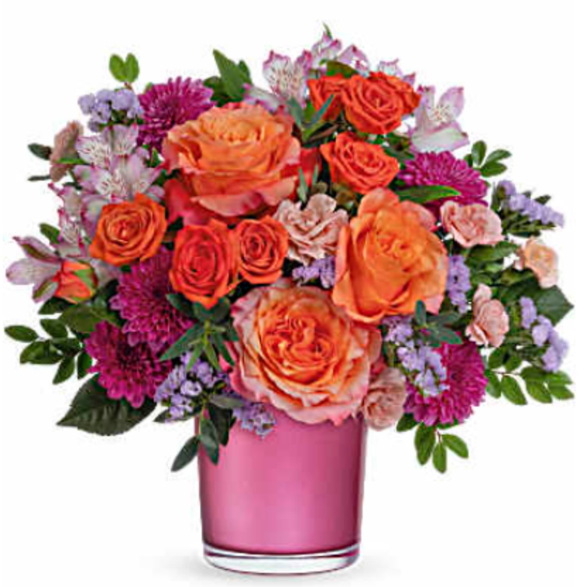Orange roses and purple flowers in a pink glass vase