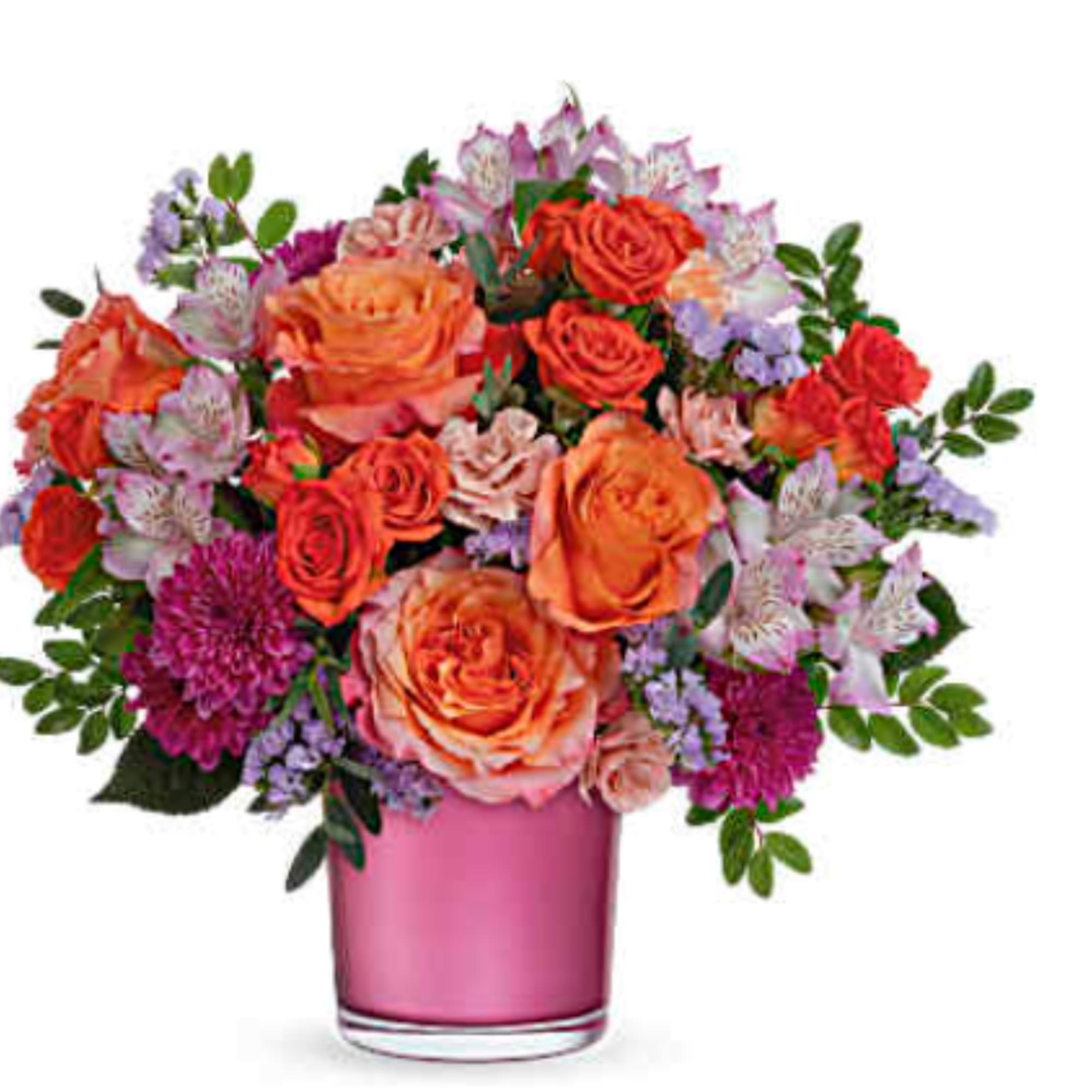 Orange and pink roses with purple flowers in a pink vase