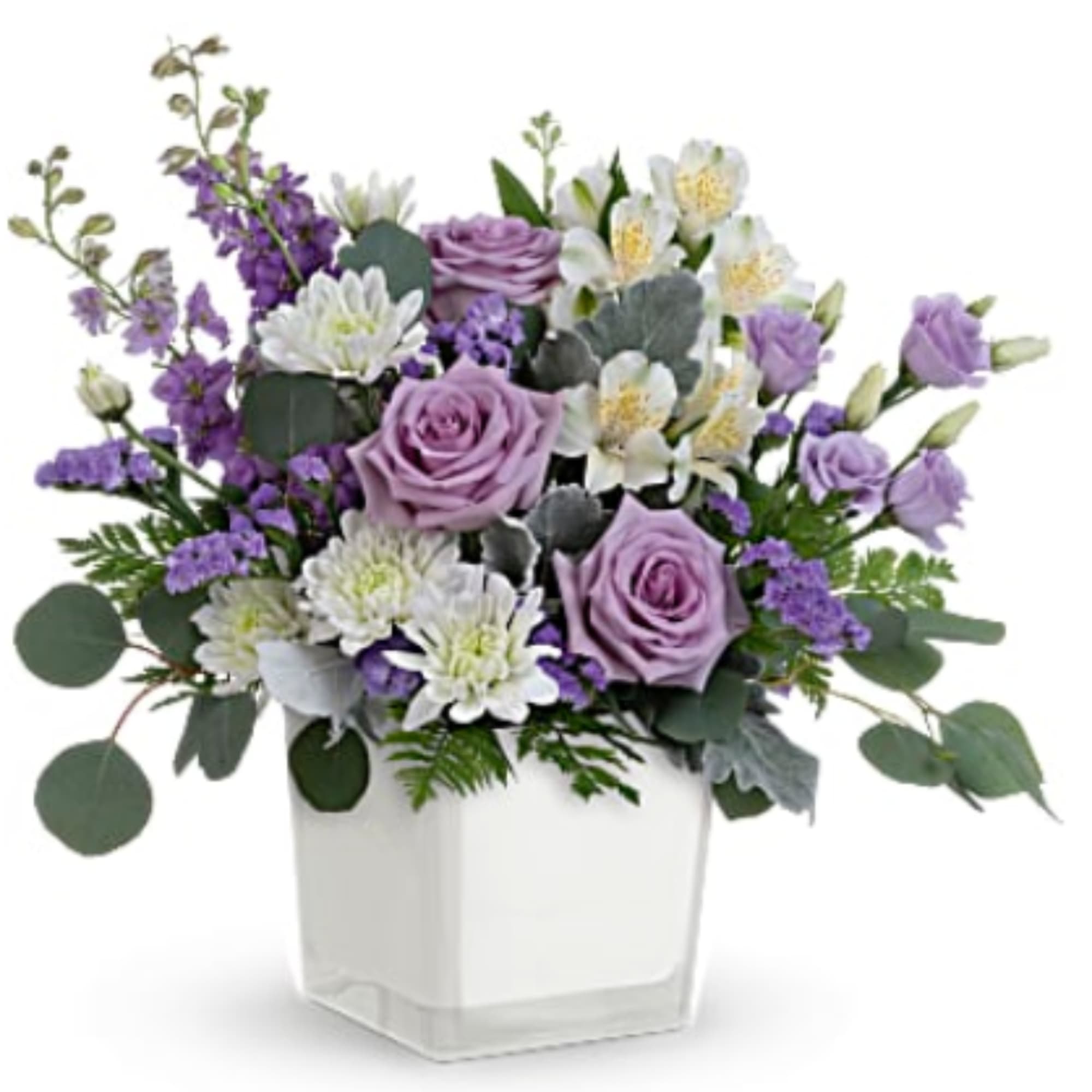 Lavender roses and white flowers in a clear square vase