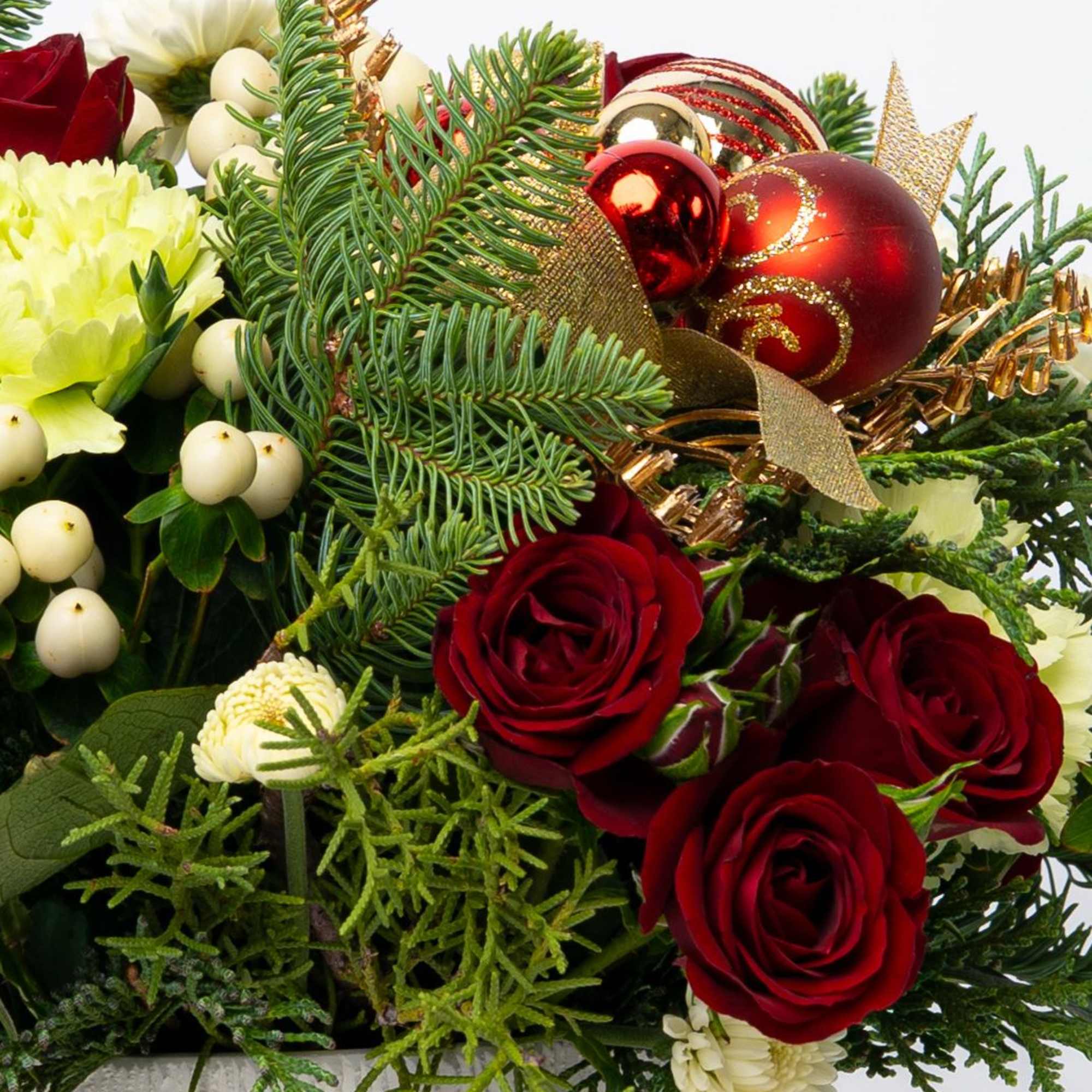 Holiday bouquet with red roses, white blooms, and gold ornaments