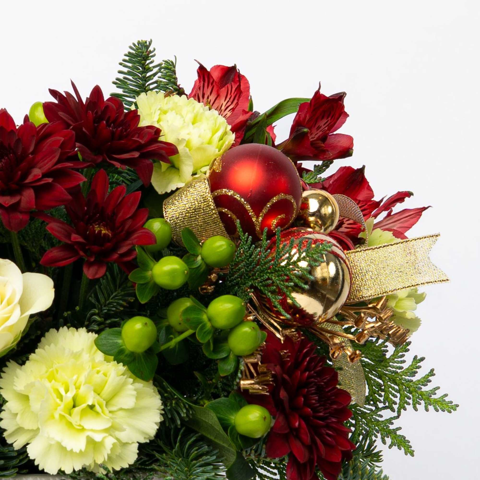 Holiday bouquet with red and cream flowers, gold ornaments, and ribbon