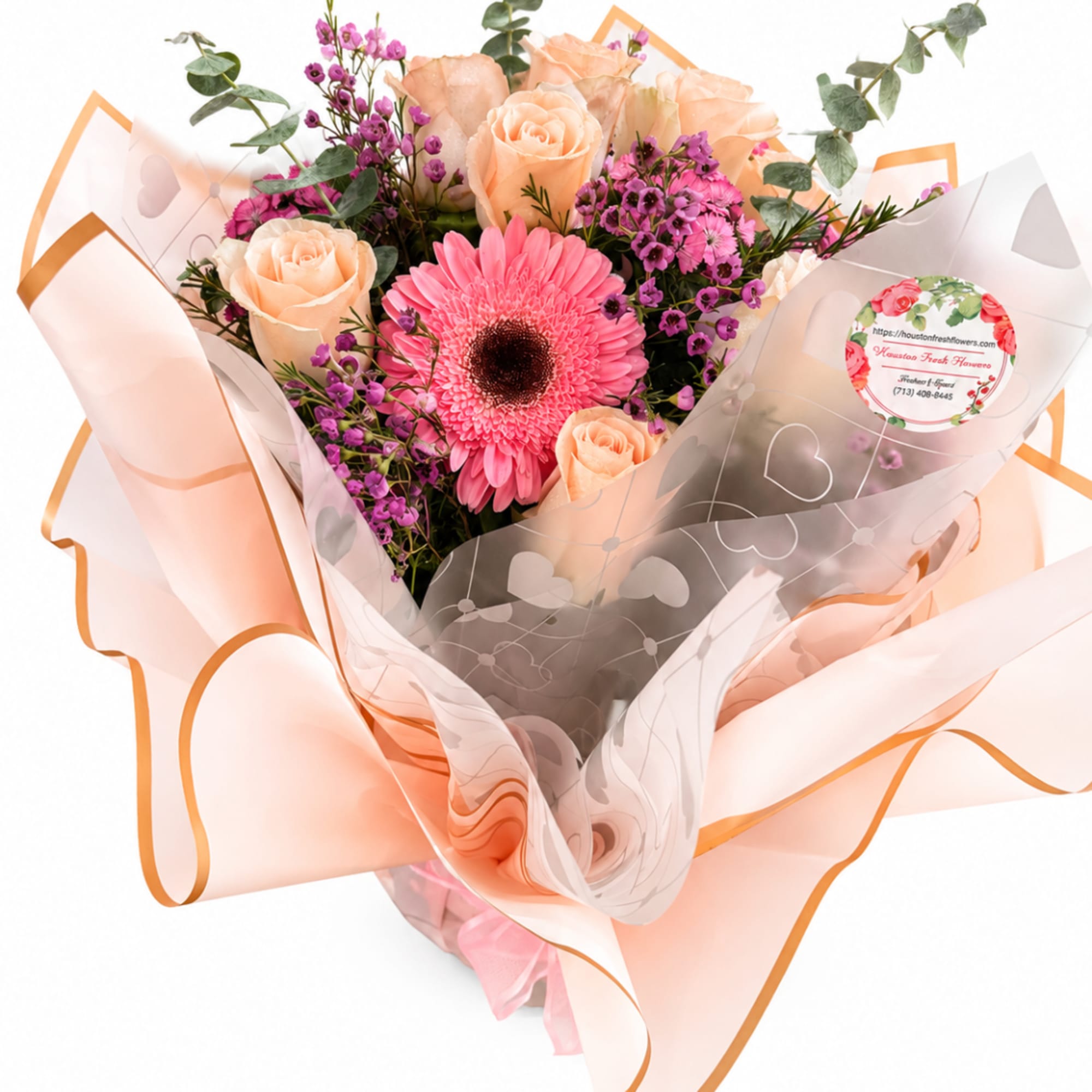 Bouquet of peach roses and pink gerbera daisies wrapped in peach paper