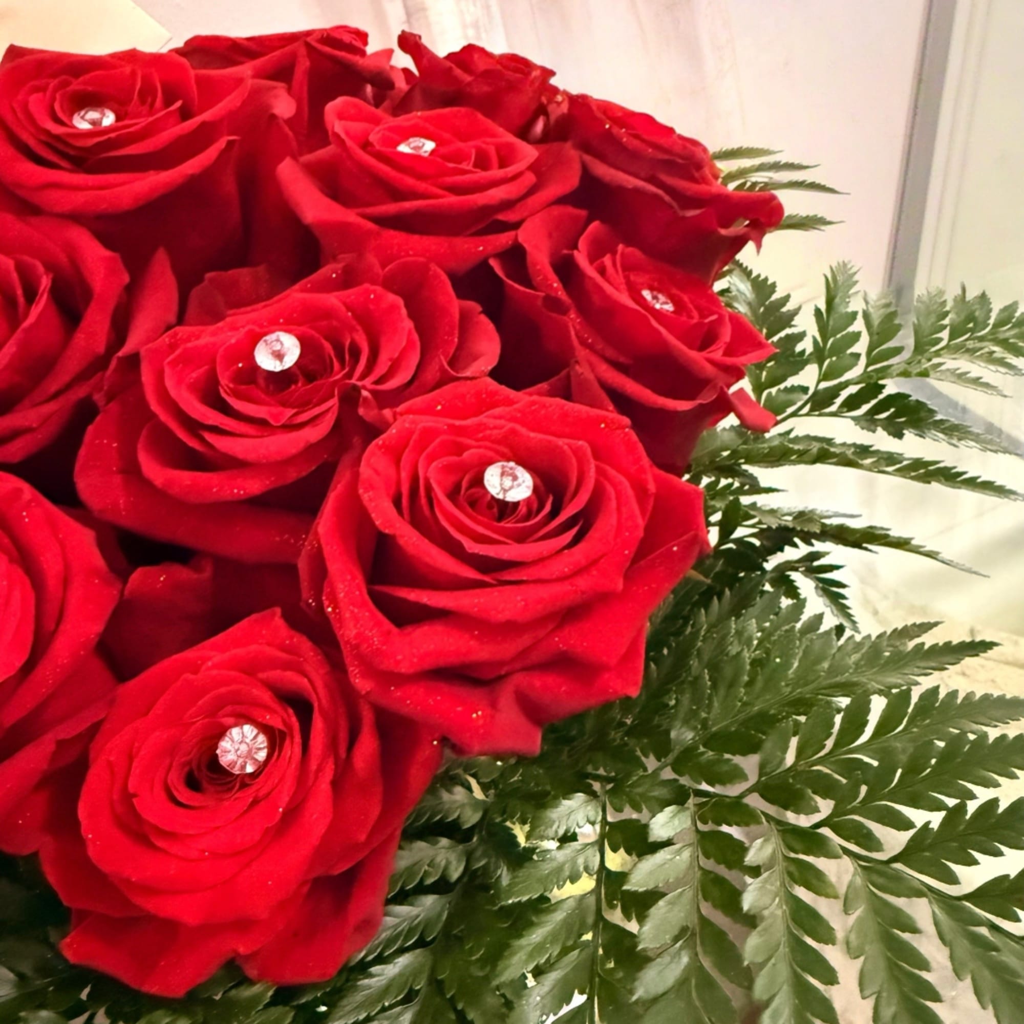 Bouquet of red roses with fern foliage