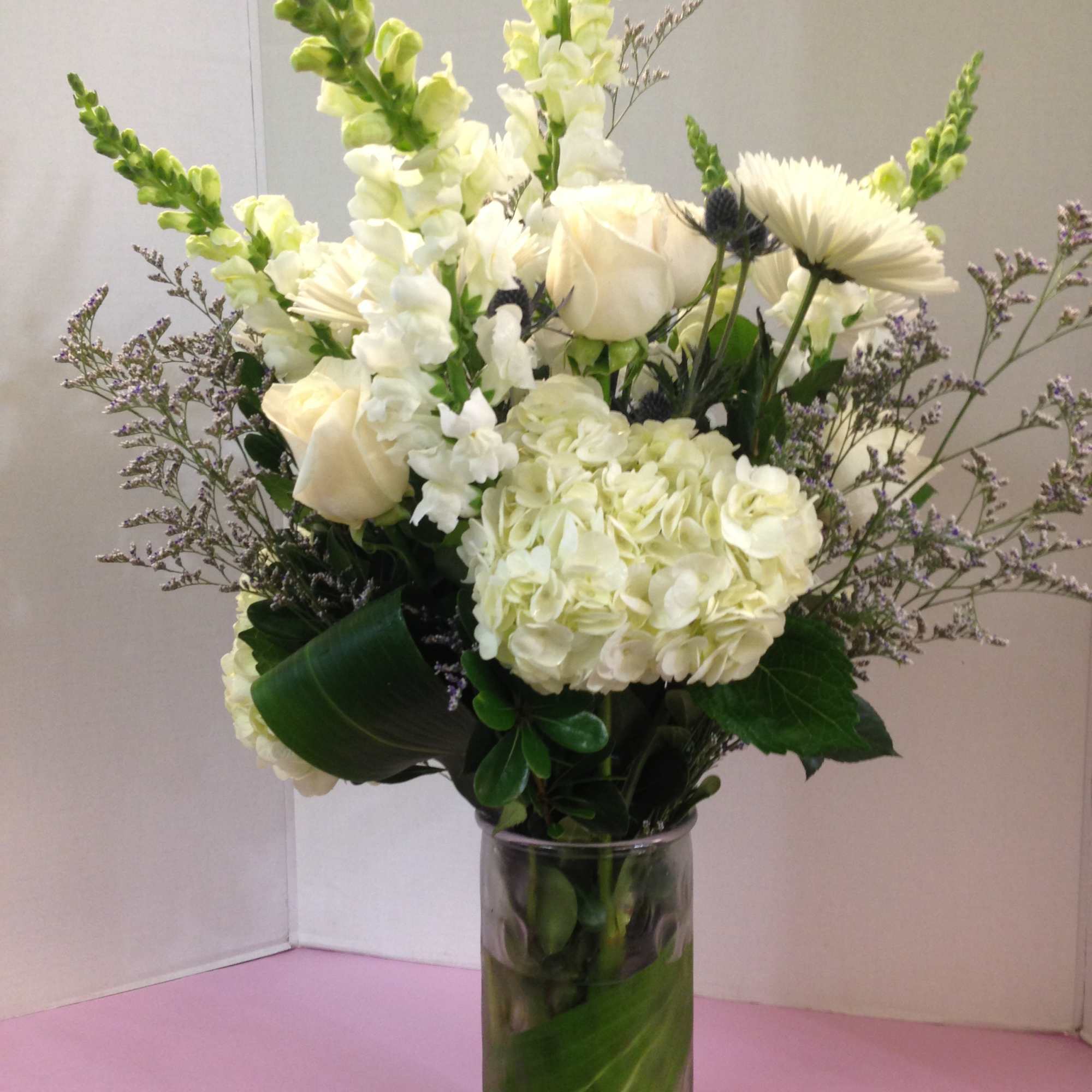 White floral arrangement in a clear glass vase
