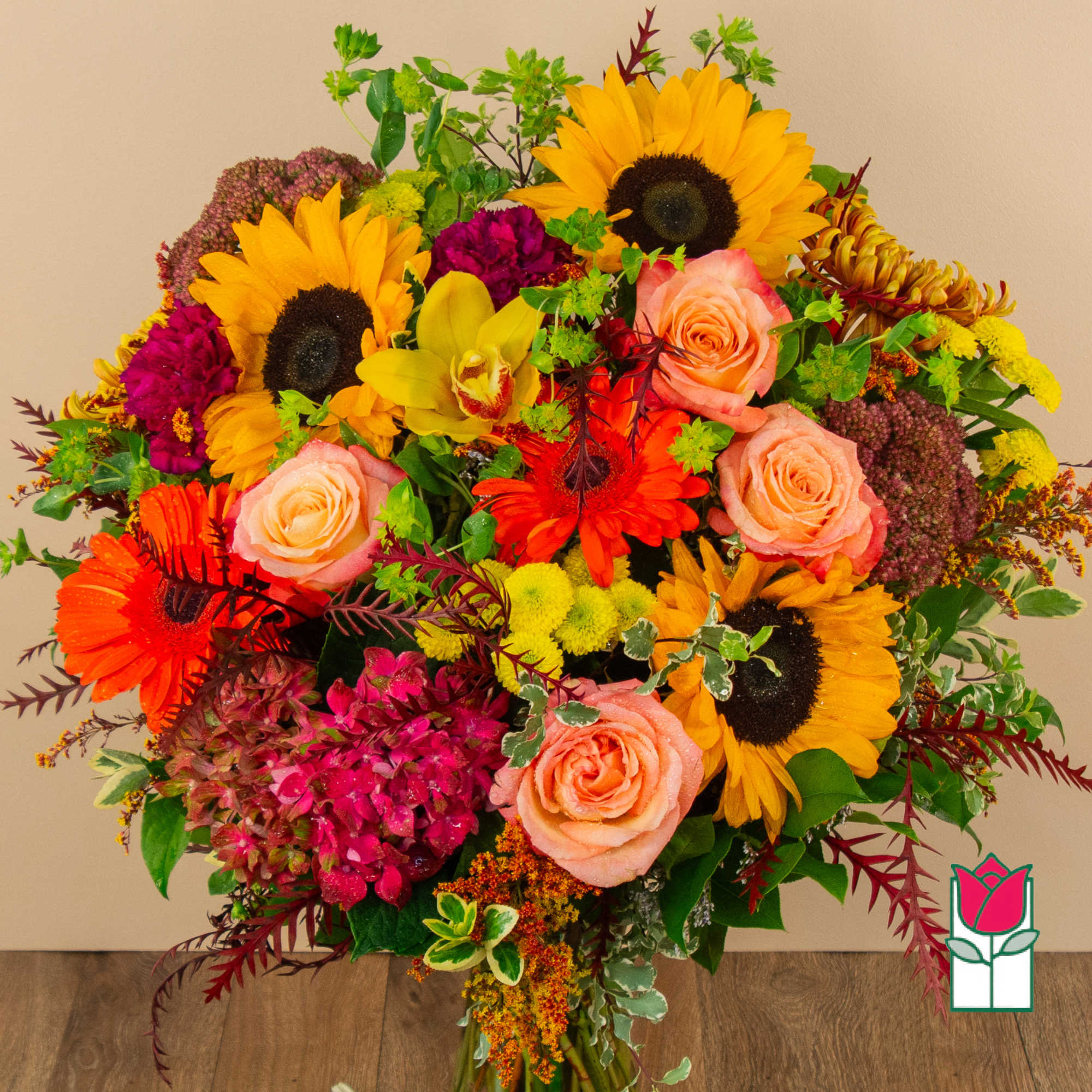 Mixed bouquet with sunflowers, peach roses, and bright orange gerberas
