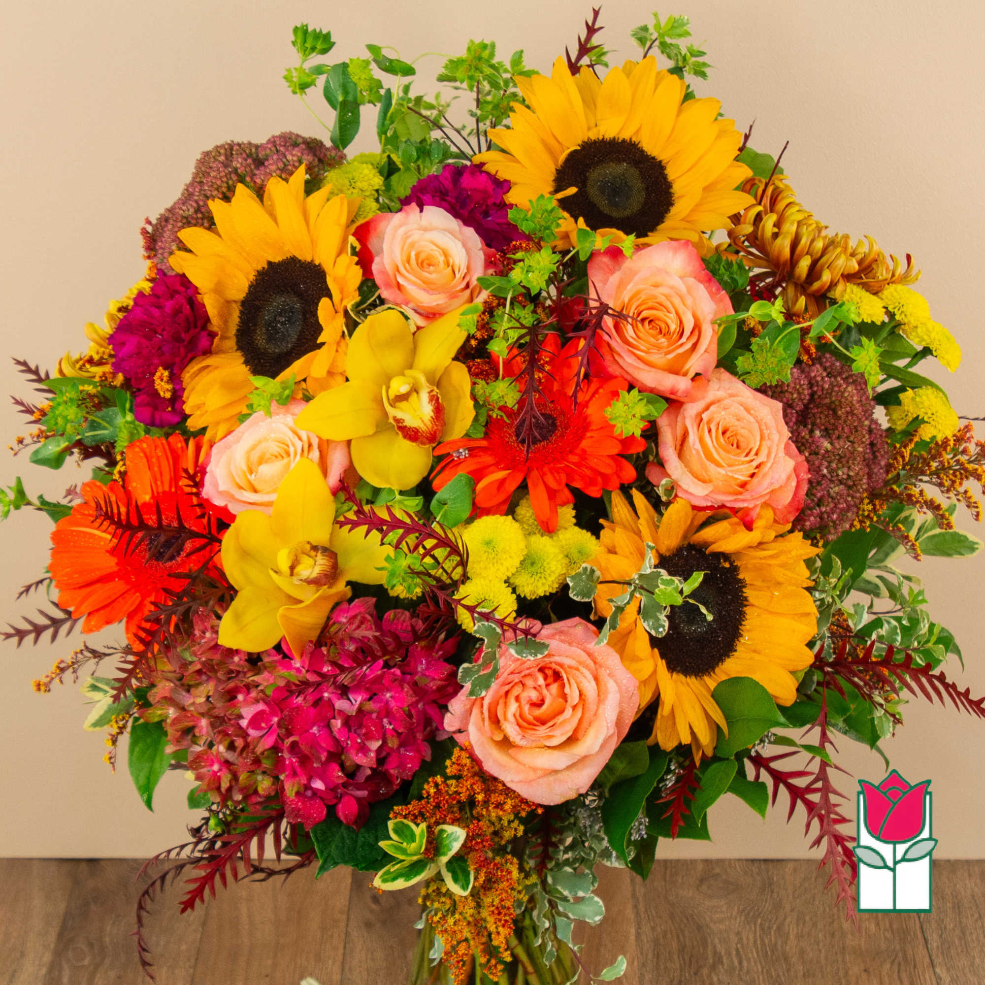 Bright mixed bouquet with sunflowers, roses, orchids, and chrysanthemums