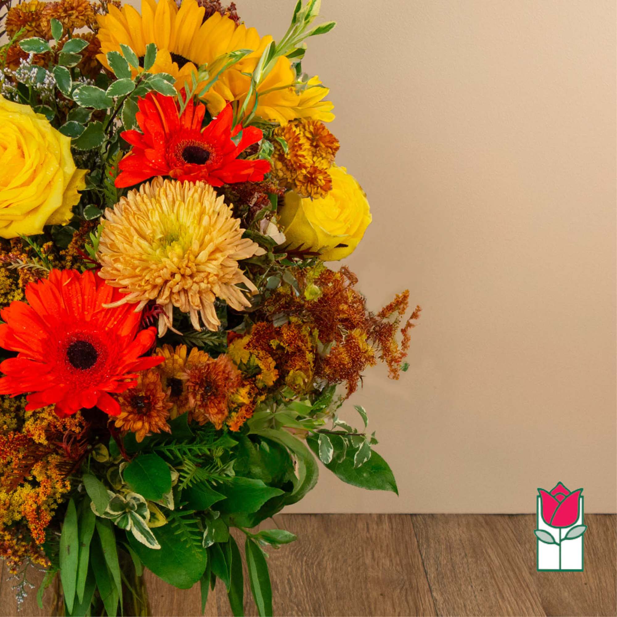 Bright mixed bouquet with yellow and red flowers against a plain wall