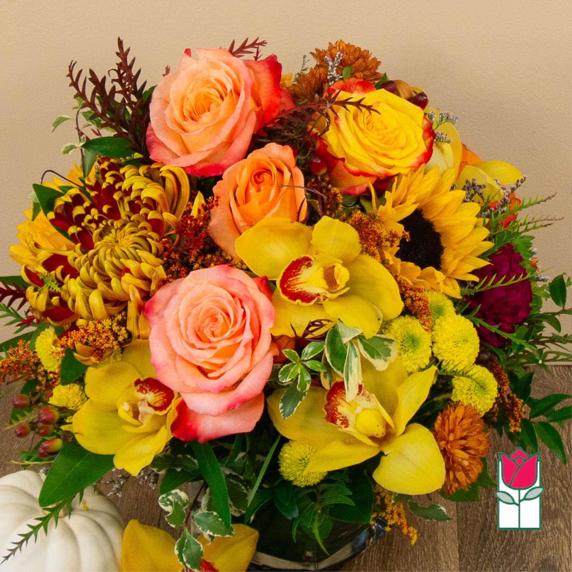 Colorful bouquet with roses, orchids, sunflowers, and mums in a vase