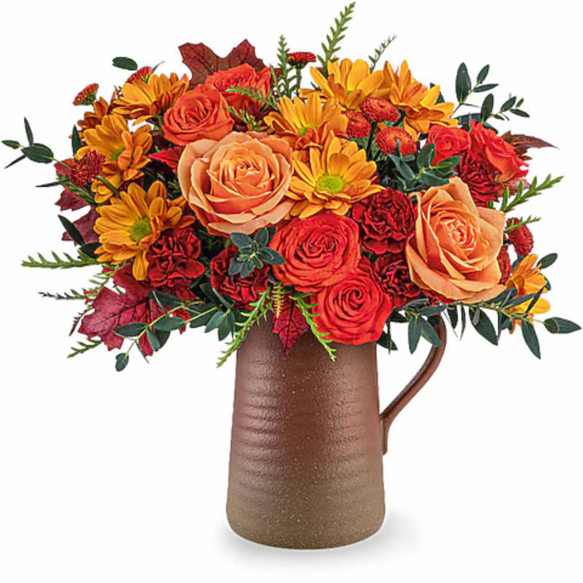 Orange and red flower arrangement in a brown pitcher vase