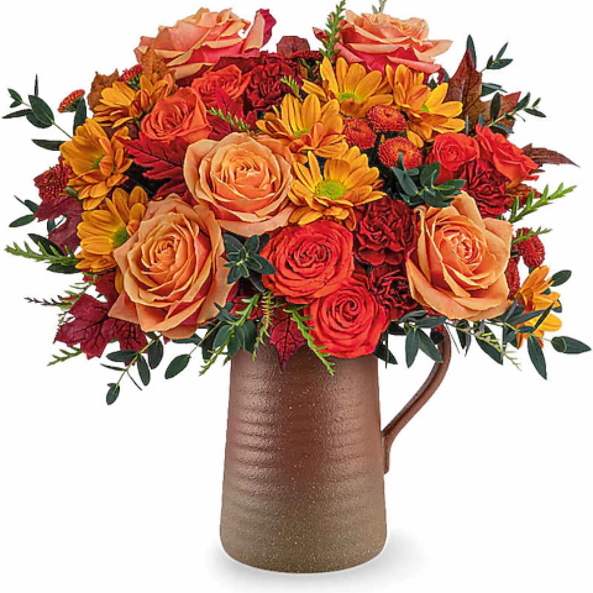 Orange and red flower arrangement in a brown pitcher vase