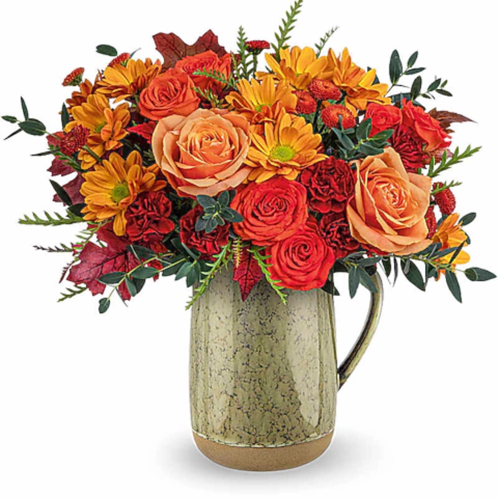 Orange and red flower arrangement in a ceramic pitcher vase