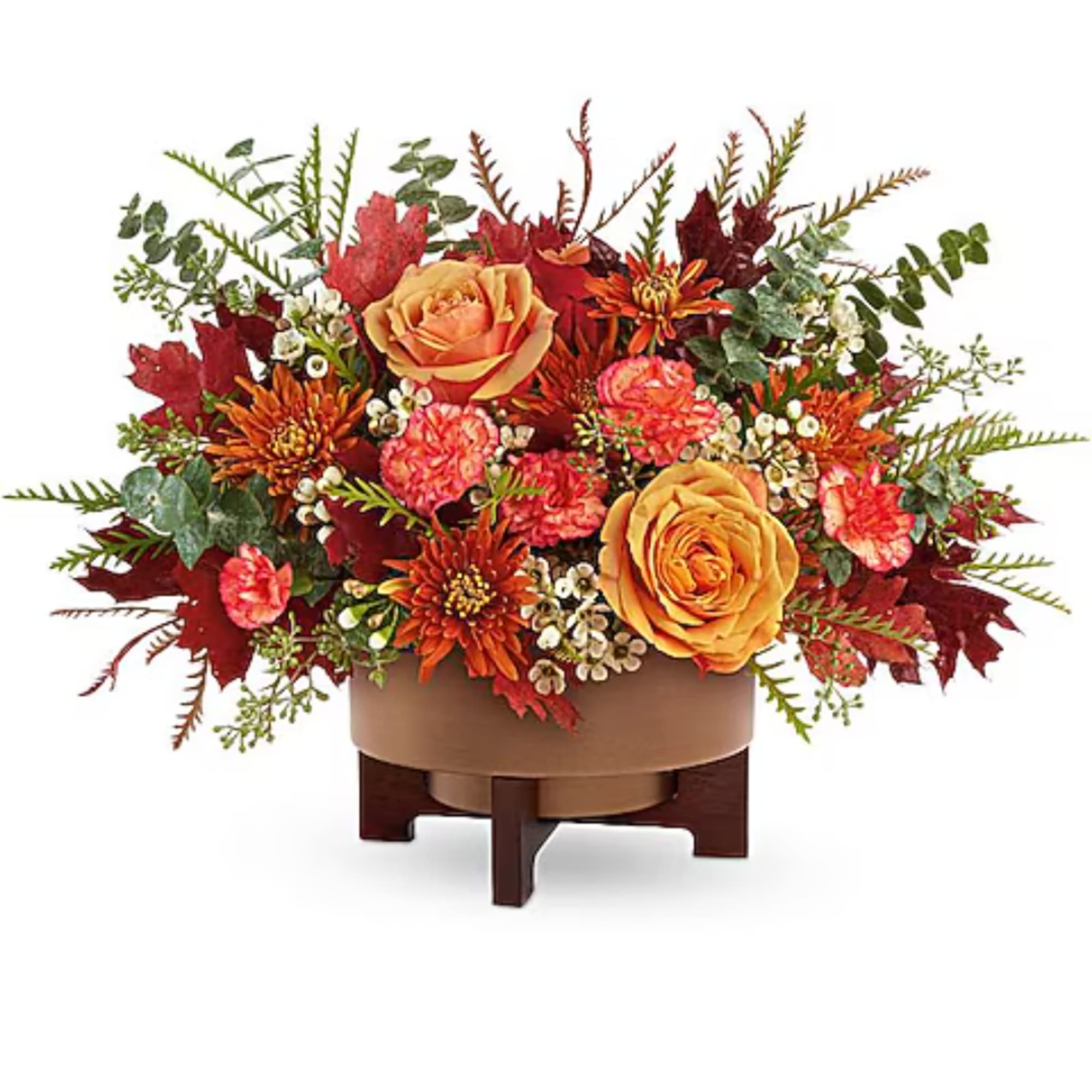 Autumn floral arrangement with orange roses in a low round container