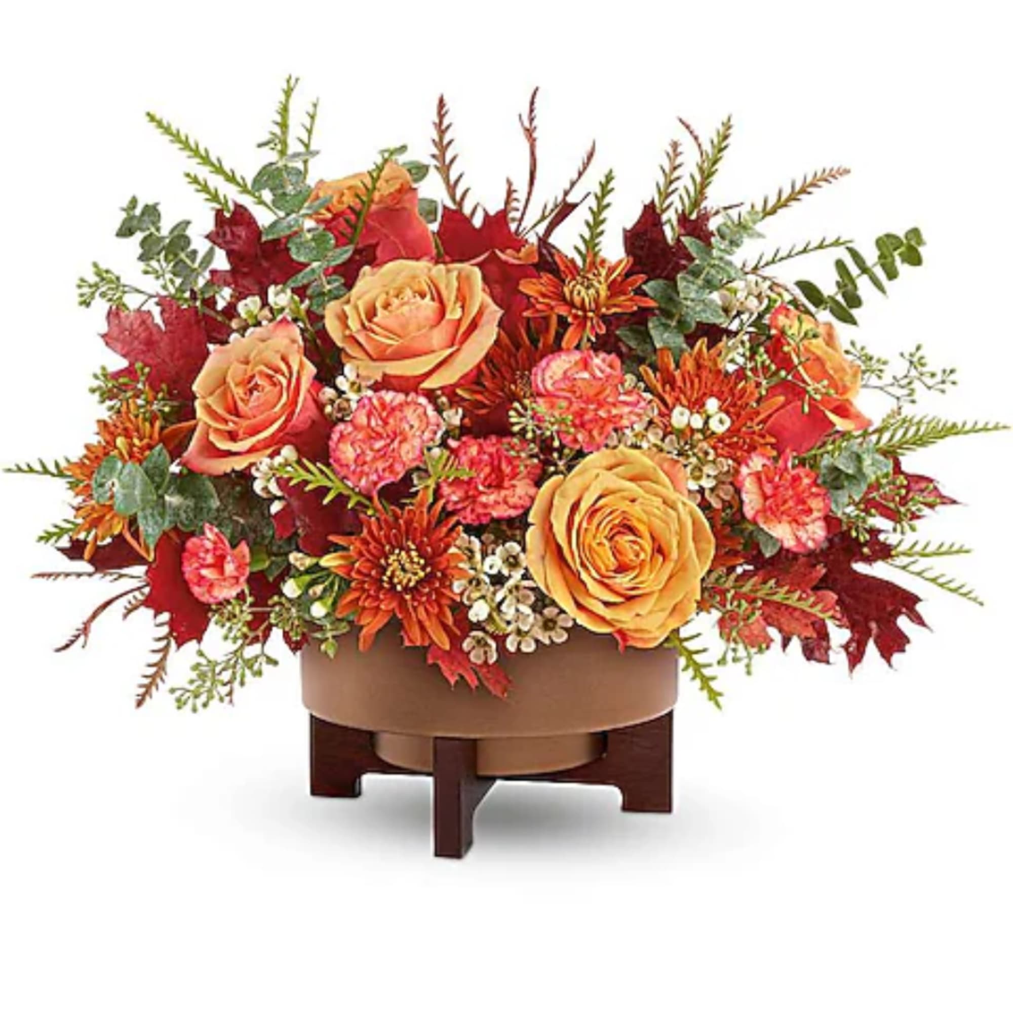 Autumn floral arrangement with orange roses and mums in a low container