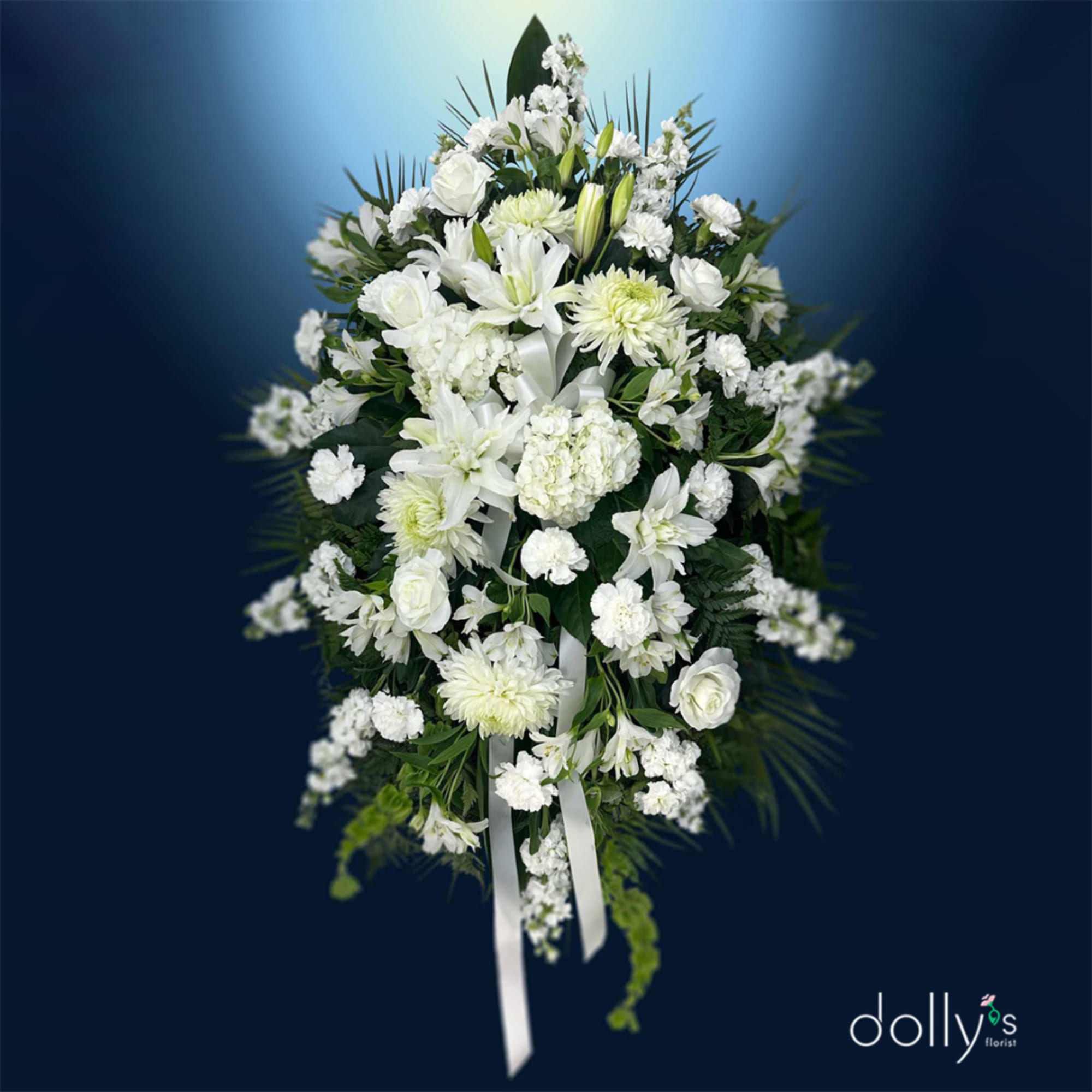 White floral standing spray with lilies, roses, and chrysanthemums