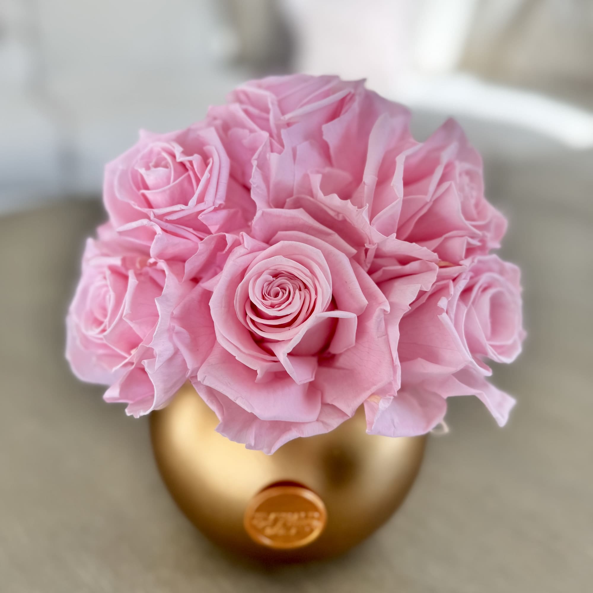 Pink roses arranged in a gold vase