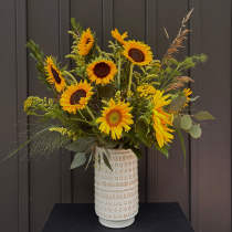 Sunflower arrangement in a patterned ceramic vase