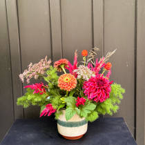 Bright mixed flower arrangement in a ceramic pot