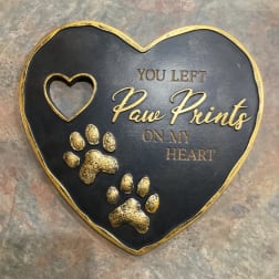 Heart-shaped memorial plaque with gold paw prints and text