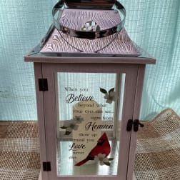 Decorative lantern with a memorial quote and cardinal graphic