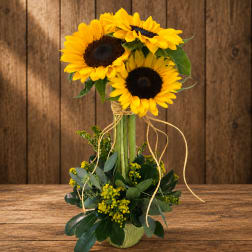 Sunflower arrangement in a vase with ribbon and greenery