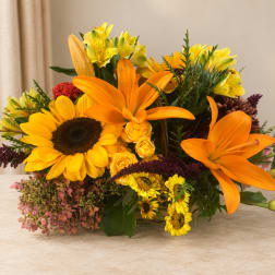 Bouquet of orange lilies, sunflowers, and yellow mixed blooms