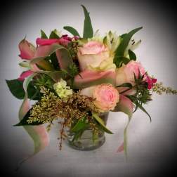 Pink and cream bouquet in a clear glass vase