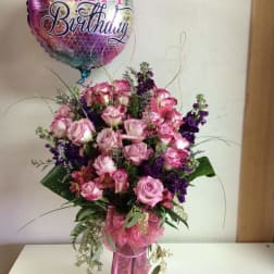 Pink and purple rose bouquet with a Happy Birthday balloon