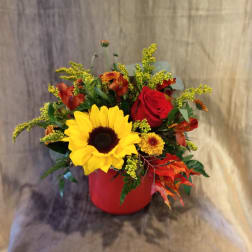 Sunflower and red rose arrangement in a red vase