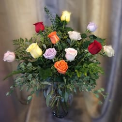 Mixed roses in a glass vase with greenery