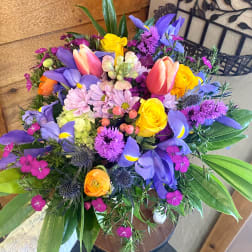 Colorful bouquet with tulips, roses, and purple blooms