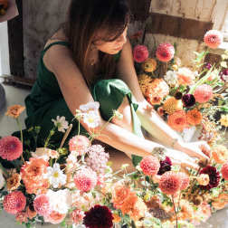 Woman arranging colorful flowers on the floor