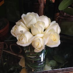 White roses arranged in a clear glass vase