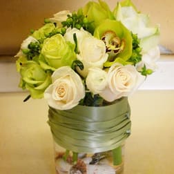 Bouquet of white and green roses in a glass vase