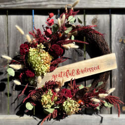 Fall wreath with dried flowers and a "grateful & blessed" sign