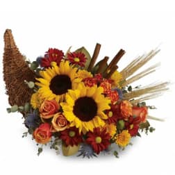 Sunflowers and mixed fall flowers in a woven cornucopia basket