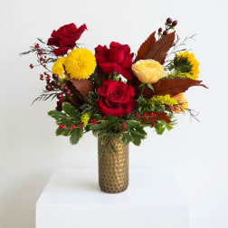 Red and yellow roses in a gold vase