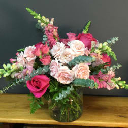 Pink and white rose bouquet in a glass vase