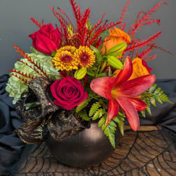 Colorful floral arrangement in a black vase with roses and lilies
