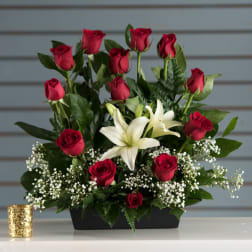 Arrangement of red roses and white lilies in a low black rectangular container