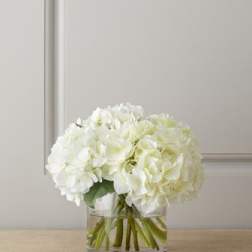 White hydrangea bouquet in a clear glass vase