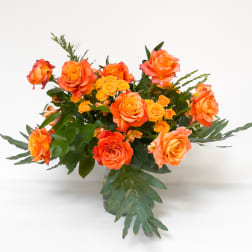 Orange roses arranged in a clear glass vase