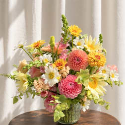 Colorful mixed bouquet in a clear glass vase on a table