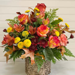 Mixed bouquet of roses, alstroemeria, and mums in a birch-style container