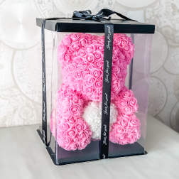 Pink rose teddy bear in a clear gift box with a black ribbon