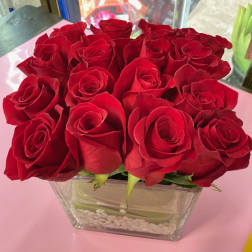 Bouquet of red roses in a clear square vase