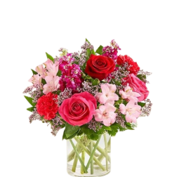 Pink and red mixed bouquet in a clear glass vase