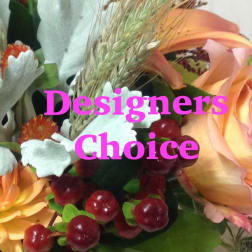 Close-up of a designers choice bouquet with peach roses, orange blooms, red berries, and white accents